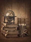 21643463-stack-of-books-and-globe-on-wooden-table